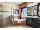 Bathroom featuring a glass enclosed shower, garden tub, and dark cabinets at 3955 Equine Cv, Lake Mary, FL 32746