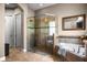 Bathroom featuring a glass enclosed shower, garden tub, and neutral colors at 3955 Equine Cv, Lake Mary, FL 32746