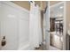 Bright white bathroom with subway tile shower and white shower curtain adjacent to wood look tile flooring at 3955 Equine Cv, Lake Mary, FL 32746