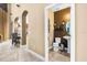 Powder room featuring a modern toilet, pedestal sink, decorative lighting, and brown accent wall at 3955 Equine Cv, Lake Mary, FL 32746