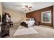 Neutral bedroom with carpet flooring featuring a dark wood bed and brown accents with a ceiling fan at 3955 Equine Cv, Lake Mary, FL 32746