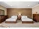 Bright bedroom with two beds, neutral carpet, and simple, elegant decor at 3955 Equine Cv, Lake Mary, FL 32746