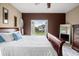 Cozy bedroom featuring a queen bed with white linens, and a large window offering a view of the outdoors at 3955 Equine Cv, Lake Mary, FL 32746
