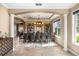 Elegant dining room with a large table, shelving units, and natural light at 3955 Equine Cv, Lake Mary, FL 32746