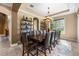 Formal dining room featuring a long wooden table with seating for twelve and a modern chandelier at 3955 Equine Cv, Lake Mary, FL 32746