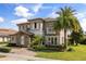 Elegant exterior features include stone accents, a balcony, lush landscaping, and a brick-paved driveway at 3955 Equine Cv, Lake Mary, FL 32746