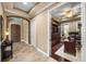 Hallway with tile flooring leads to the office area and a dark brown entry door at 3955 Equine Cv, Lake Mary, FL 32746