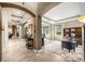 Hallway with multiple archways connecting to various rooms, tile floors, and neutral paint colors at 3955 Equine Cv, Lake Mary, FL 32746