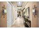 Hallway has recessed lighting, decorative wall sconces, neutral paint, arched doorways, and tile flooring at 3955 Equine Cv, Lake Mary, FL 32746