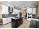 Spacious kitchen features stainless steel appliances, island with dark cabinets, and white perimeter cabinets at 3955 Equine Cv, Lake Mary, FL 32746