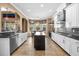 Bright kitchen featuring white cabinets, stainless steel appliances, and center island at 3955 Equine Cv, Lake Mary, FL 32746