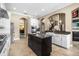 Open-concept kitchen with a large island, stainless steel appliances, and sleek white cabinets at 3955 Equine Cv, Lake Mary, FL 32746