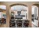 Open concept kitchen includes breakfast bar with pendant lights, stainless steel appliances, and white cabinets at 3955 Equine Cv, Lake Mary, FL 32746