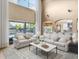 Bright living room with soaring ceilings, large windows, and access to the outdoor pool at 3955 Equine Cv, Lake Mary, FL 32746