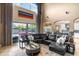 Spacious living room boasts a large sectional sofa, high ceilings, and access to the outdoor pool area at 3955 Equine Cv, Lake Mary, FL 32746