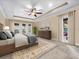 Comfortable main bedroom with tray ceiling, plush carpet, and private patio access at 3955 Equine Cv, Lake Mary, FL 32746