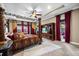 Spacious main bedroom with a large bed, decorative curtains, and access to a private outdoor seating area at 3955 Equine Cv, Lake Mary, FL 32746