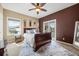 Beautifully decorated main bedroom featuring a dark wood bed frame, ceiling fan and neutral walls at 3955 Equine Cv, Lake Mary, FL 32746