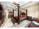Spacious bedroom with four poster bed, ceiling fan, and sitting area at 3955 Equine Cv, Lake Mary, FL 32746
