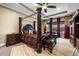 Spacious bedroom with four poster bed, ceiling fan, and sitting area at 3955 Equine Cv, Lake Mary, FL 32746