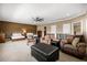 Spacious main bedroom with two queen beds, seating area, and neutral walls create a relaxing atmosphere at 3955 Equine Cv, Lake Mary, FL 32746