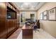 Comfortable home office featuring custom built-ins, a large desk, and a cozy chair for productive work at 3955 Equine Cv, Lake Mary, FL 32746