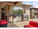 Outdoor kitchen features a stainless steel grill, granite counters, and storage at 3955 Equine Cv, Lake Mary, FL 32746