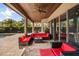 Covered patio with wood ceiling featuring comfortable seating and glass sliding doors into the main house at 3955 Equine Cv, Lake Mary, FL 32746