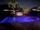 Night view of a swimming pool and landscaped backyard at 3955 Equine Cv, Lake Mary, FL 32746