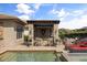Outdoor pool bar area with stone facade, wooden stools, and red lounging sofas for entertaining guests at 3955 Equine Cv, Lake Mary, FL 32746