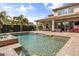 Resort-style backyard pool area featuring a covered patio, brick pool deck and tropical landscaping at 3955 Equine Cv, Lake Mary, FL 32746