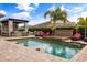 Backyard oasis with a sparkling pool, jacuzzi, poolside bar, and lounge chairs for relaxing at 3955 Equine Cv, Lake Mary, FL 32746