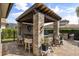 Outdoor kitchen with brick pillars, built in seating, and a full bar at 3955 Equine Cv, Lake Mary, FL 32746