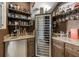 Custom wine room featuring a wine refrigerator and custom built-in shelving at 3955 Equine Cv, Lake Mary, FL 32746