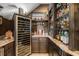 Custom wine room featuring a wine refrigerator and custom built-in shelving at 3955 Equine Cv, Lake Mary, FL 32746