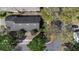 An aerial shot reveals the home's roof, landscaping, driveway, and proximity to the street at 406 Ravenshill Way, Deland, FL 32724