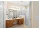 Bright bathroom with double vanity, framed mirror, glass shower, and tiled floor at 406 Ravenshill Way, Deland, FL 32724