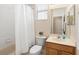 Standard bathroom features a tub with shower, toilet, and vanity at 406 Ravenshill Way, Deland, FL 32724