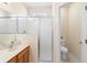 Bright bathroom featuring a glass-enclosed shower and adjacent toilet room at 406 Ravenshill Way, Deland, FL 32724