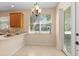 Bright dining area with chandelier, tiled floor, and views of the street at 406 Ravenshill Way, Deland, FL 32724