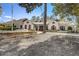 Traditional home with dormer windows, red shutters, stone accents and 3-car garage at 406 Ravenshill Way, Deland, FL 32724