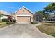 Charming single-Gathering home boasting a two-car garage and well-manicured landscaping at 406 Ravenshill Way, Deland, FL 32724