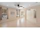 Spacious living room with tiled floors, open archways, recessed lights, and large windows providing ample natural light at 406 Ravenshill Way, Deland, FL 32724