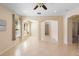 Bright living room with tiled floors, open archways, recessed lights, and large windows providing ample natural light at 406 Ravenshill Way, Deland, FL 32724