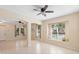 Spacious living room with tiled floors, open archways, recessed lights, and a window seat at 406 Ravenshill Way, Deland, FL 32724