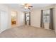 Spacious main bedroom with ensuite bathroom, carpeted floor, and natural lighting at 406 Ravenshill Way, Deland, FL 32724