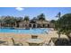 Enjoy the pool with easy access entry, palm trees, lounge chairs and tables at 406 Ravenshill Way, Deland, FL 32724