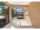 View of the screened-in lanai which overlooks the backyard at 406 Ravenshill Way, Deland, FL 32724