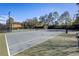 Several tennis courts are lined with a green barrier, black fence, and net at 406 Ravenshill Way, Deland, FL 32724
