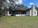 Exterior of home with large backyard, including a screened-in porch and mature trees at 4164 New Marsh Rd, Deland, FL 32724